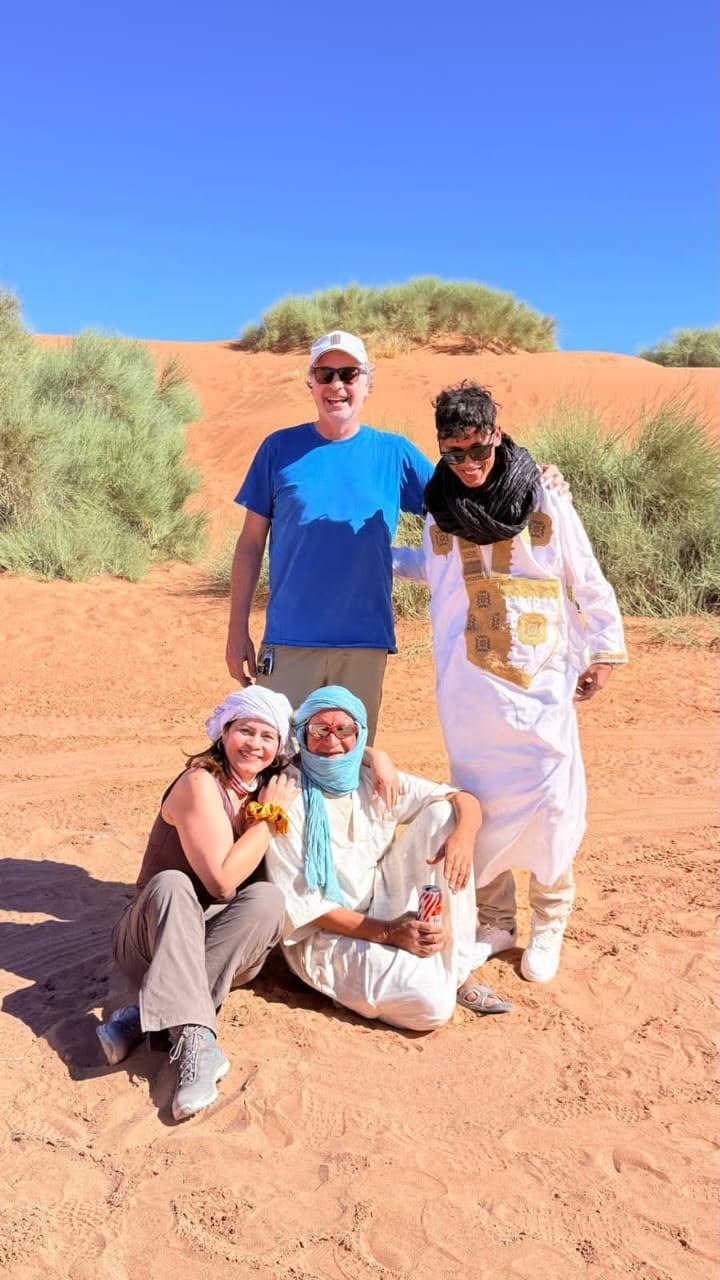 Morocco Desert Nights driver and guide team on a dune near Merzouga