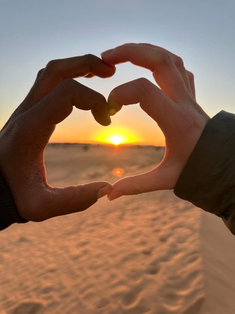 Couple watching the Sahara sunset on a private desert tour